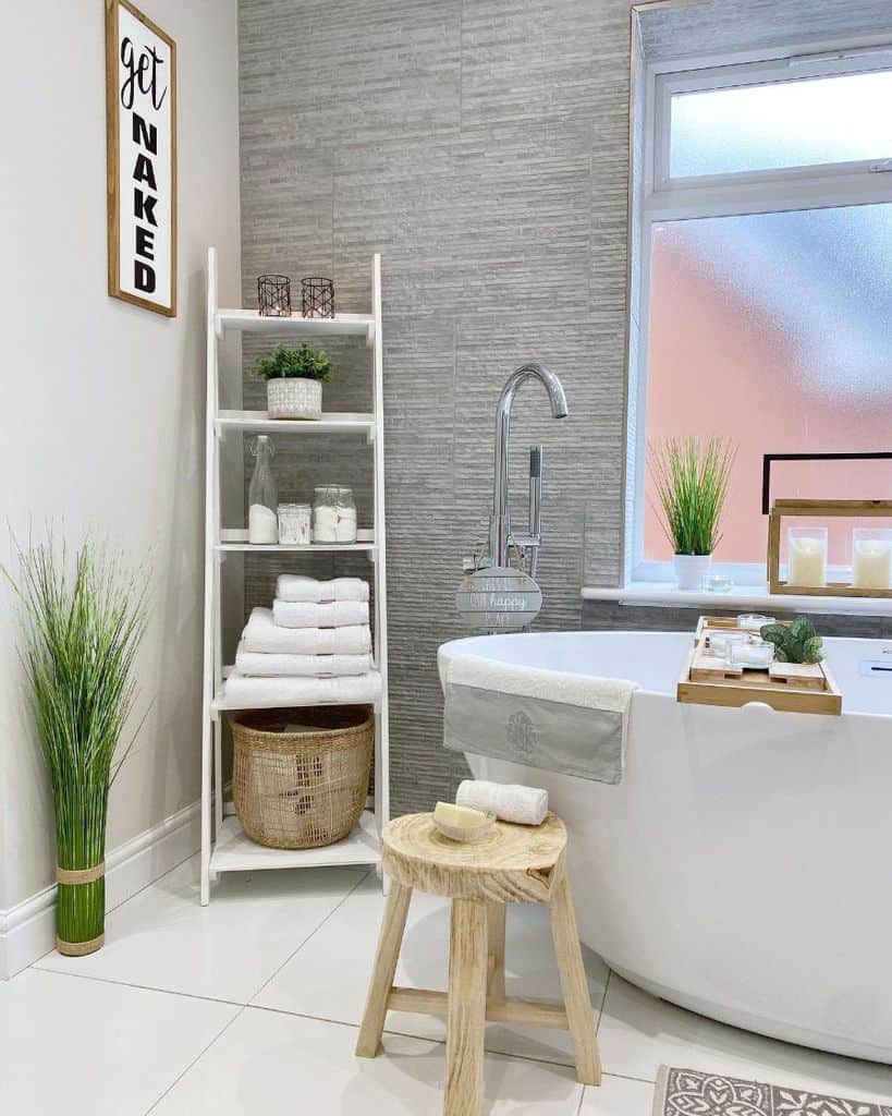 white bathroom rack and large bathtub