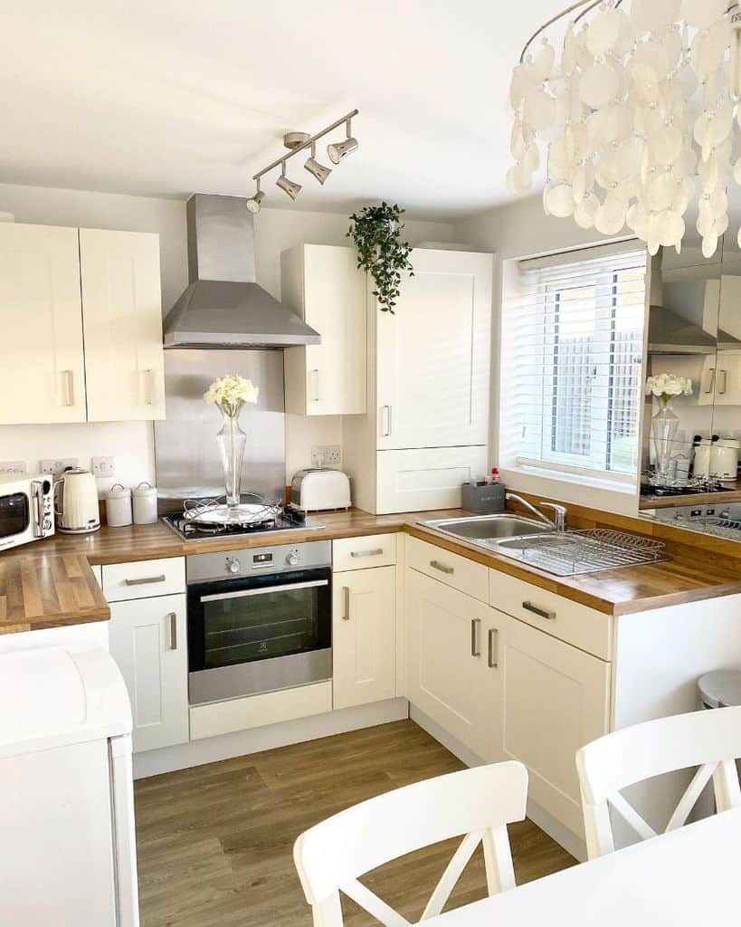 country style cream cabinet kitchen with wood countertops 