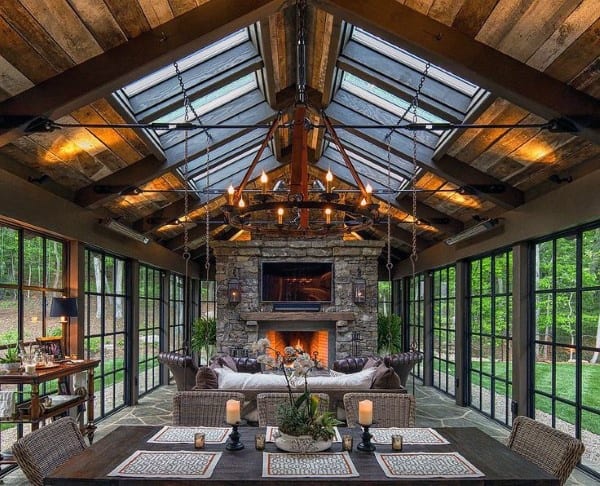 large rustic sunroom stone fireplace