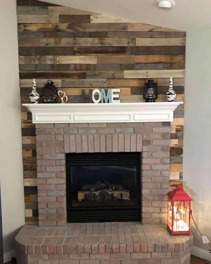 brick fireplace wood shiplap wall white mantle red lantern 