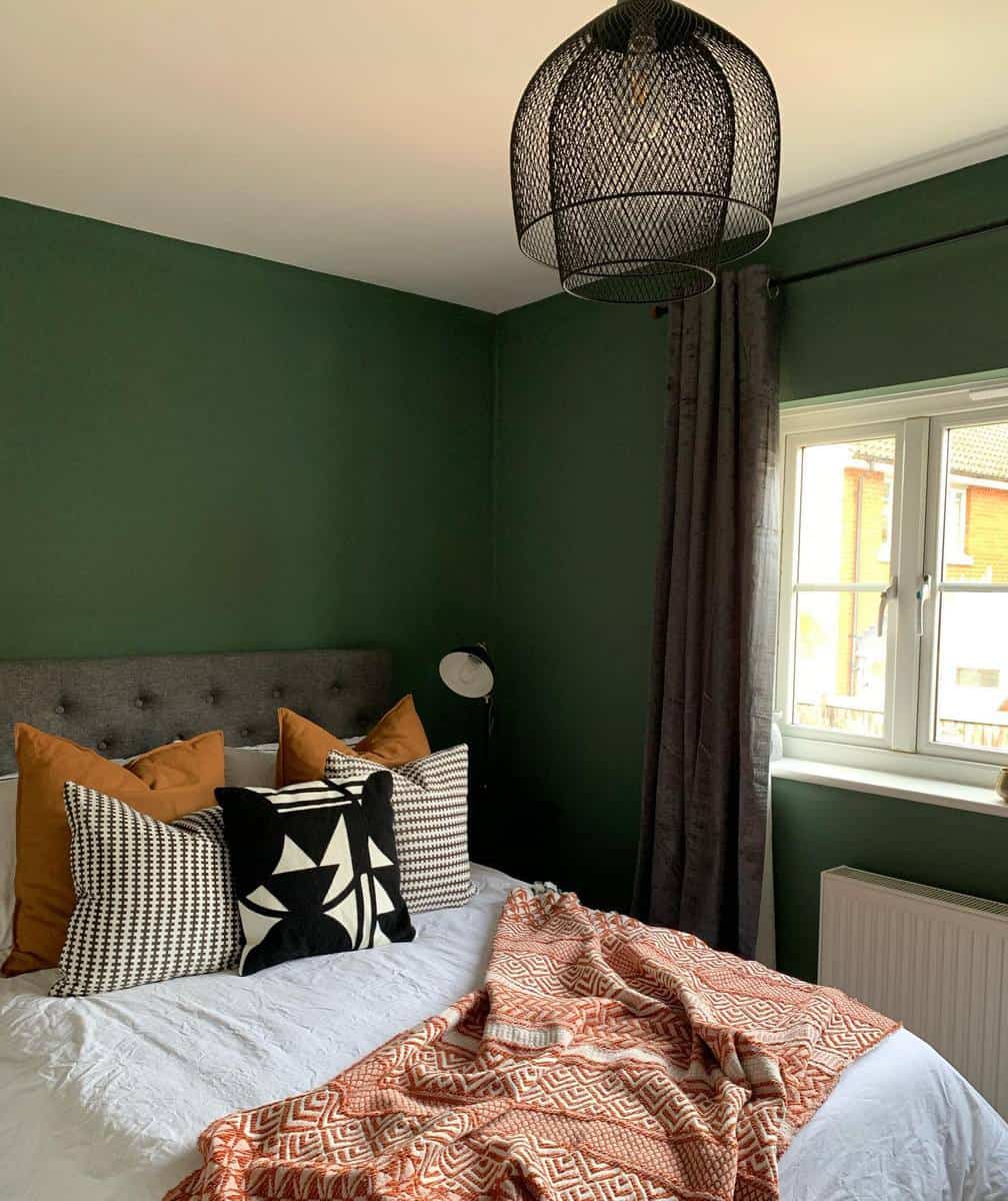 green guest room earthy pillows and bedspread 