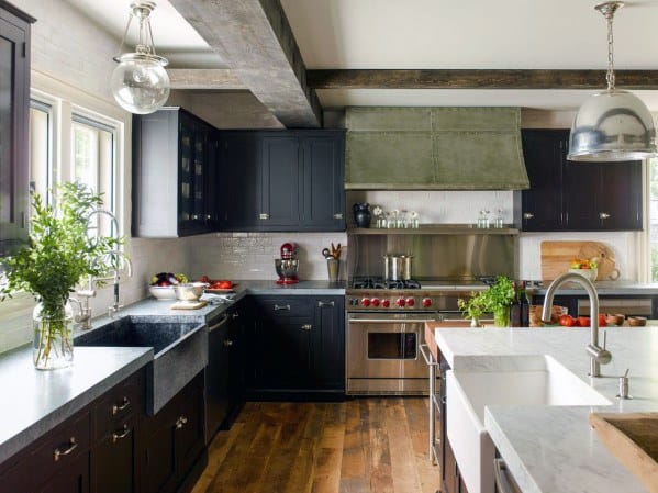 rustic kitchen with black cabinets marble countertops and hardwood flooor 