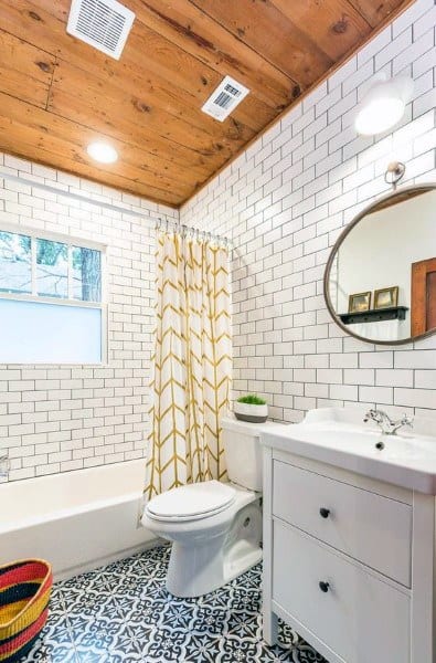 wood roof white tile walls blue pattern tile floor bathroom