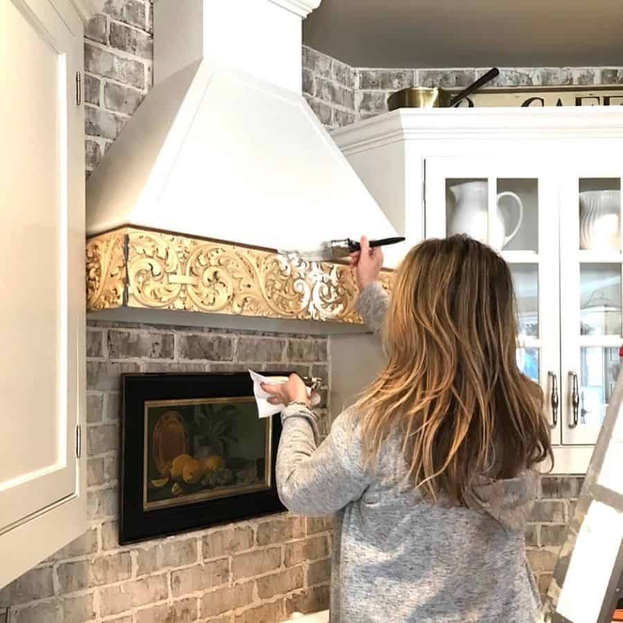 white kitchen hood french country kitchen gray brick splashback 