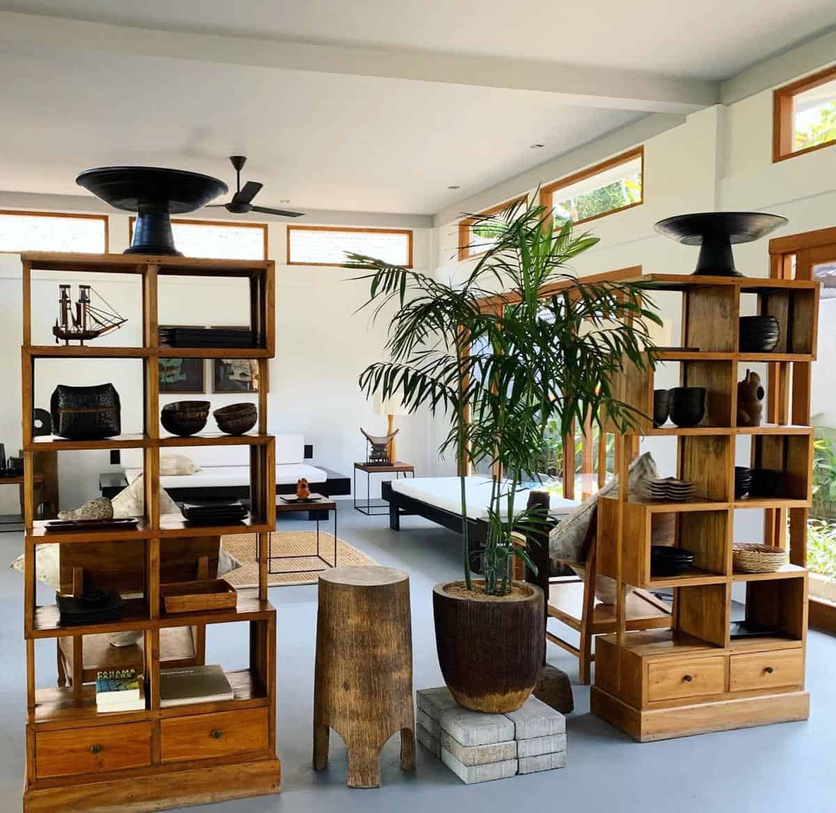 two wood wall dividers in living room with shelves 