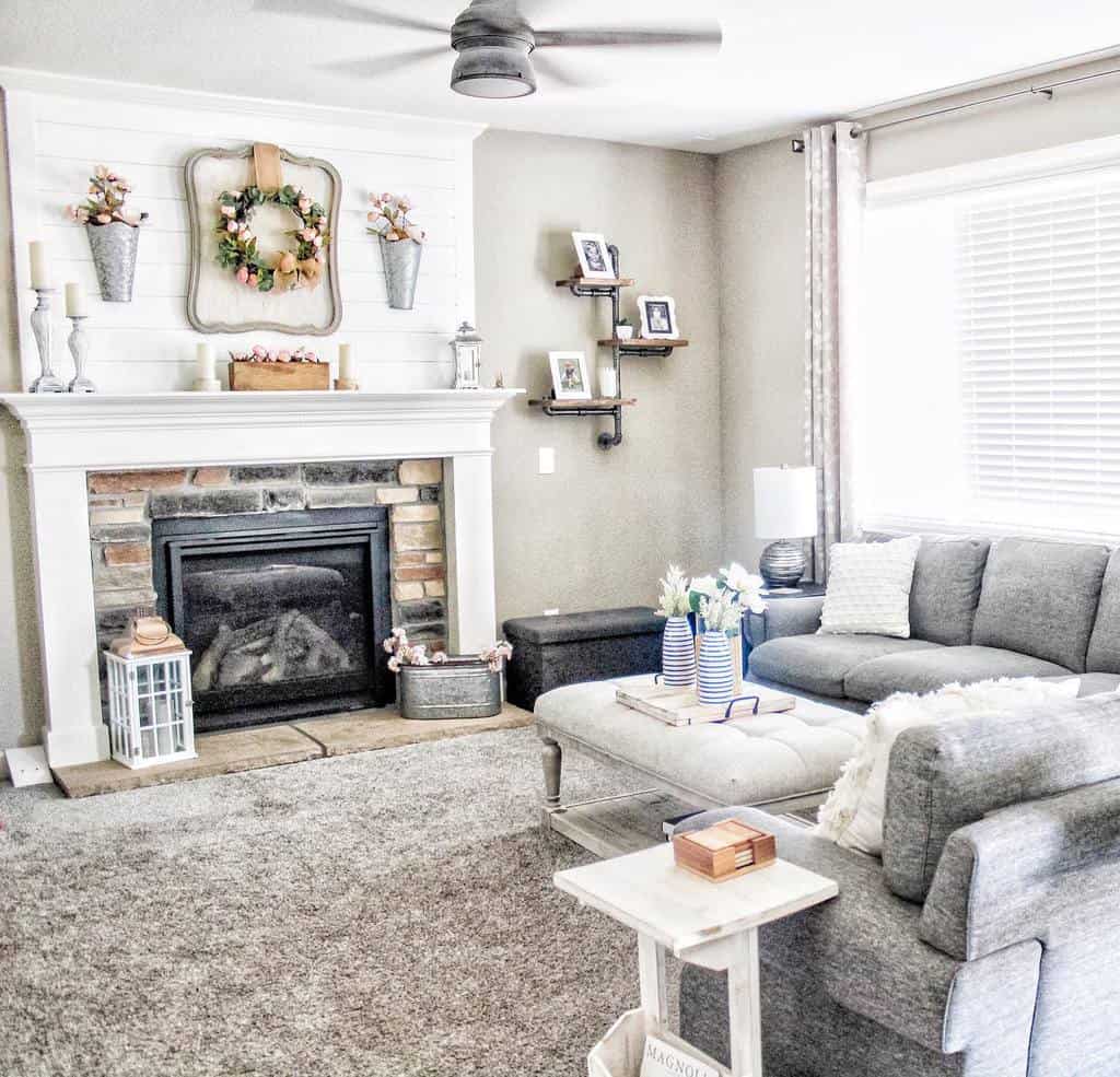 rustic living room stone fireplace gray sofa white shiplap wall 