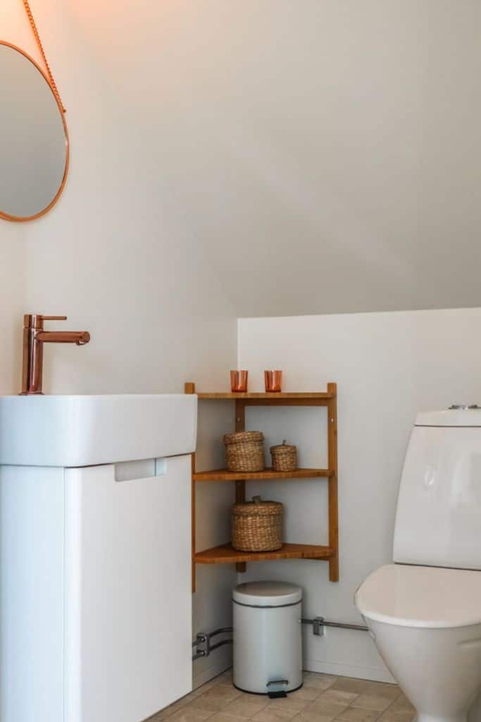 simple small powder room with bronze accents 