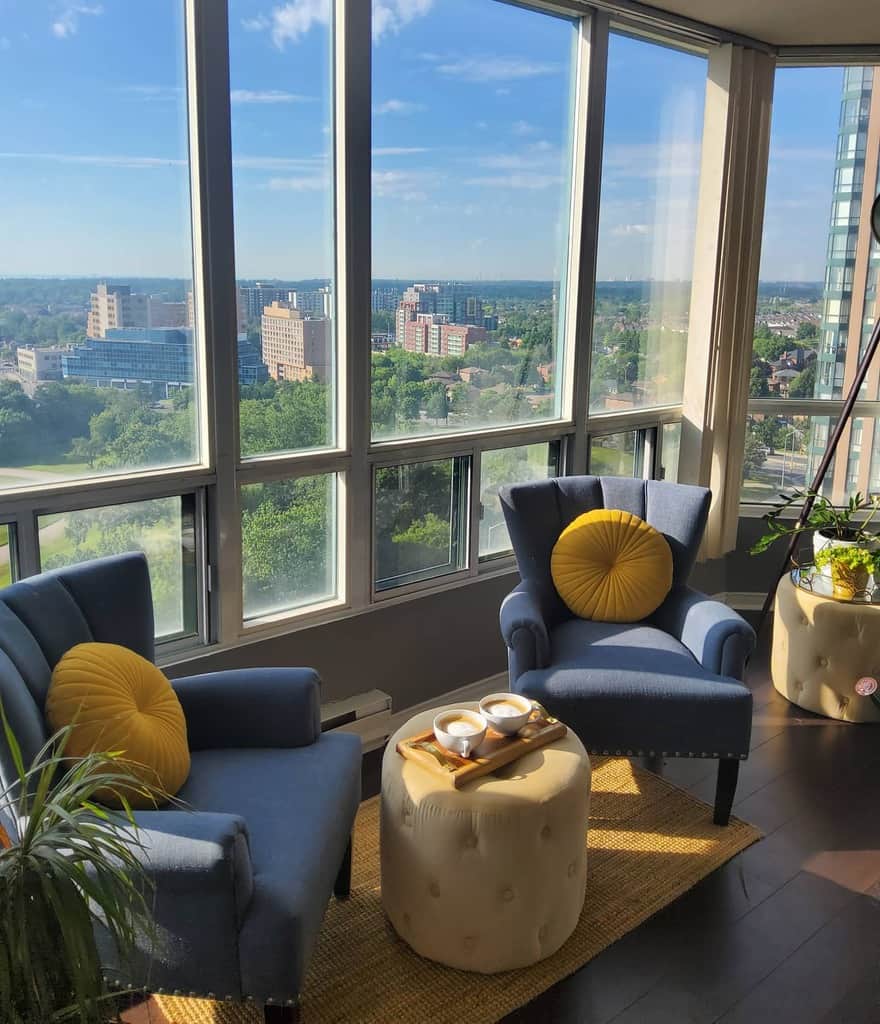 apartment sunroom blue chairs city view