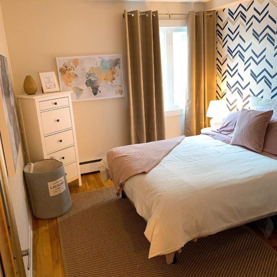 small bedroom with pattern wallpaper and white corner cabinet 