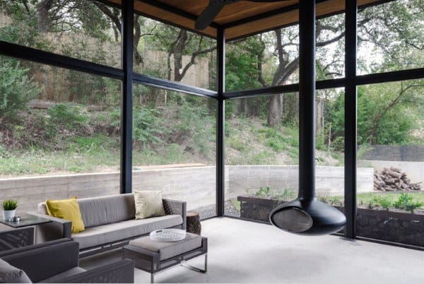 large high ceiling sunroom modern fireplace