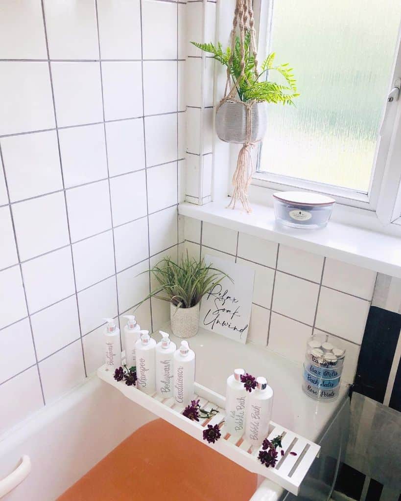 white tiled bathroom with bathtub tray