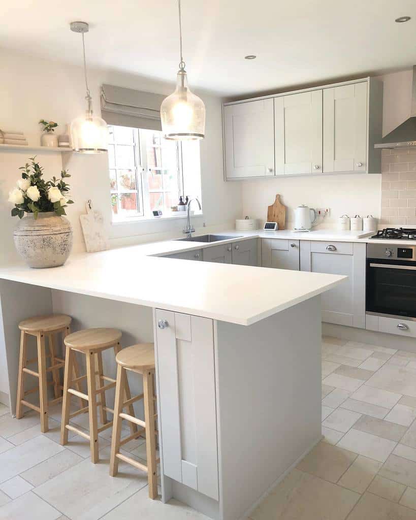 all-white kitchen pendant lights three wood stools under bench 